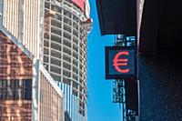 Currency euro or dollar sign on singboard against 