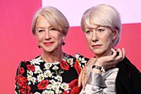 Dame Helen Mirren views three of her wax works at 