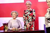 Dame Helen Mirren views three of her wax works at 