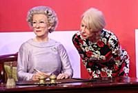 Dame Helen Mirren views three of her wax works at 