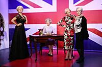Dame Helen Mirren views three of her wax works at 