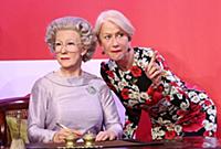 Dame Helen Mirren views three of her wax works at 