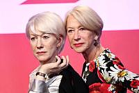 Dame Helen Mirren views three of her wax works at 