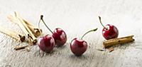 Cherry, Prunus cultivar. Four cherries with stalks