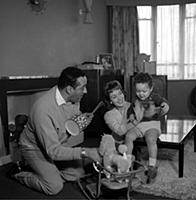 Ray Ellington, 1915-1985, at home in London with w
