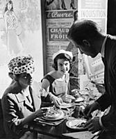 A waiter serves two ladies at lunch in Le P'tit Mo