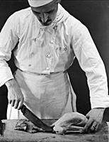 A chef prepares a chicken for cooking.
Milan, Ita