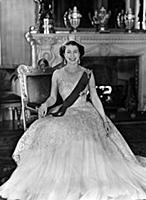 The Queen is wearing a pale pink evening gown of n
