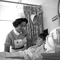 A nurse tending to her young patient on the childr