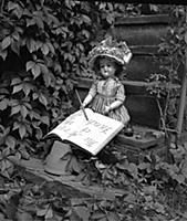 Dolls: A doll stitting on steps and pretending to 