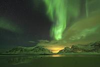 'Northern lights above a mountains with light poll