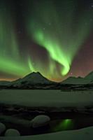 'Northern lights over frozen lake with reflection 