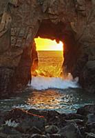 Wave crashing through Keystone Arch at sunset, Pfe