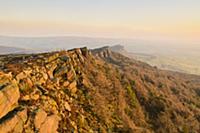 View of gritstone escarpment in afternoon sunlight