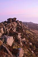View of gritstone escarpment at sunset, The Roache
