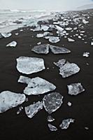Pieces of ice washed up onto the beach in Jokulsar