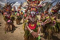 Men in ritual make-up and traditional clothing dan