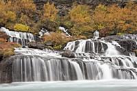 Waterfalls flowing into Hvita River in autumn, Hra