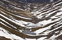 View of glacial valley habitat with snow and froze