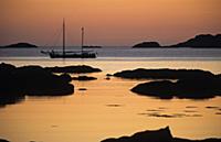 Scotland, Evening seascape, yacht cruising slowly 