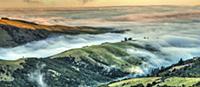 Ridges engulfed by mist at sunset, Tumbledown Bay,