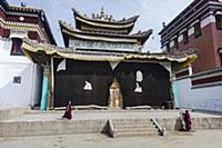 China, Tibet, Two young monks are working near the