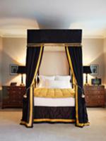 Elegant four-poster bed with black velvet canopy