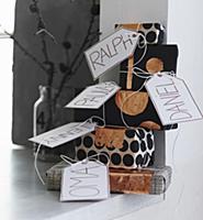 Stack of gifts wrapped in black and white paper wi