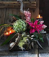 Arrangement of artichoke with Guzmania and Vriesea
