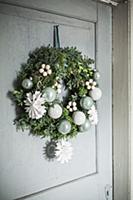 Festive door wreath with paper snowflakes and baub