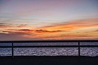 Silhouetted fence and sea at dusk, Reine, Lofoten,
