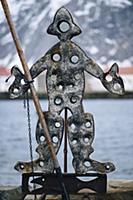 Metal sculpture of person with fishing rod