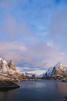 Distant view of waterfront village and snow capped