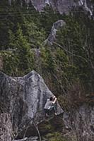 Climber bouldering in forest, Squamish, Canada