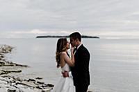 Romantic young bride and groom face to face on lak