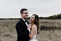 Happy young bride and groom hugging and laughing i