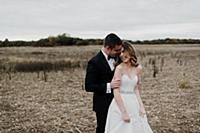 Romantic young couple in field on wedding day