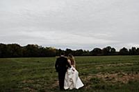 Romantic young groom carrying bride's wedding dres
