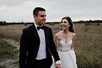 Happy young couple strolling hand in hand through 