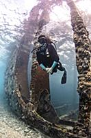 Underwater view of female scuba diver exploring Sa