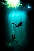 Underwater view of male and female scuba divers ex
