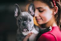 Girl hugging pet dog