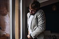 Mid adult man struggling to make smartphone call w