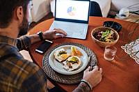 Mid adult man about to eat fried egg meal at table