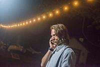 Serious young man making smartphone call at outdoo