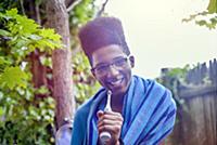 Teenage boy with afro flat top hairstyle holding e