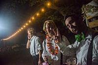 Young men making peace sign at outdoor wedding rec