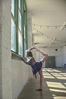 Teenage girl looking through dance studio window p
