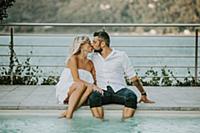 Romantic mid adult couple kissing on poolside, Str