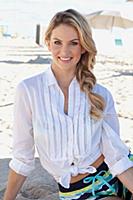 A young blonde woman wearing a white blouse and co